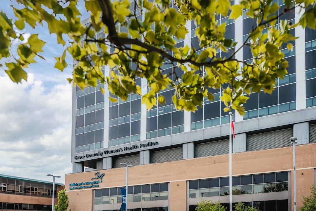military handler transition — Modern hospital building with trees in foreground