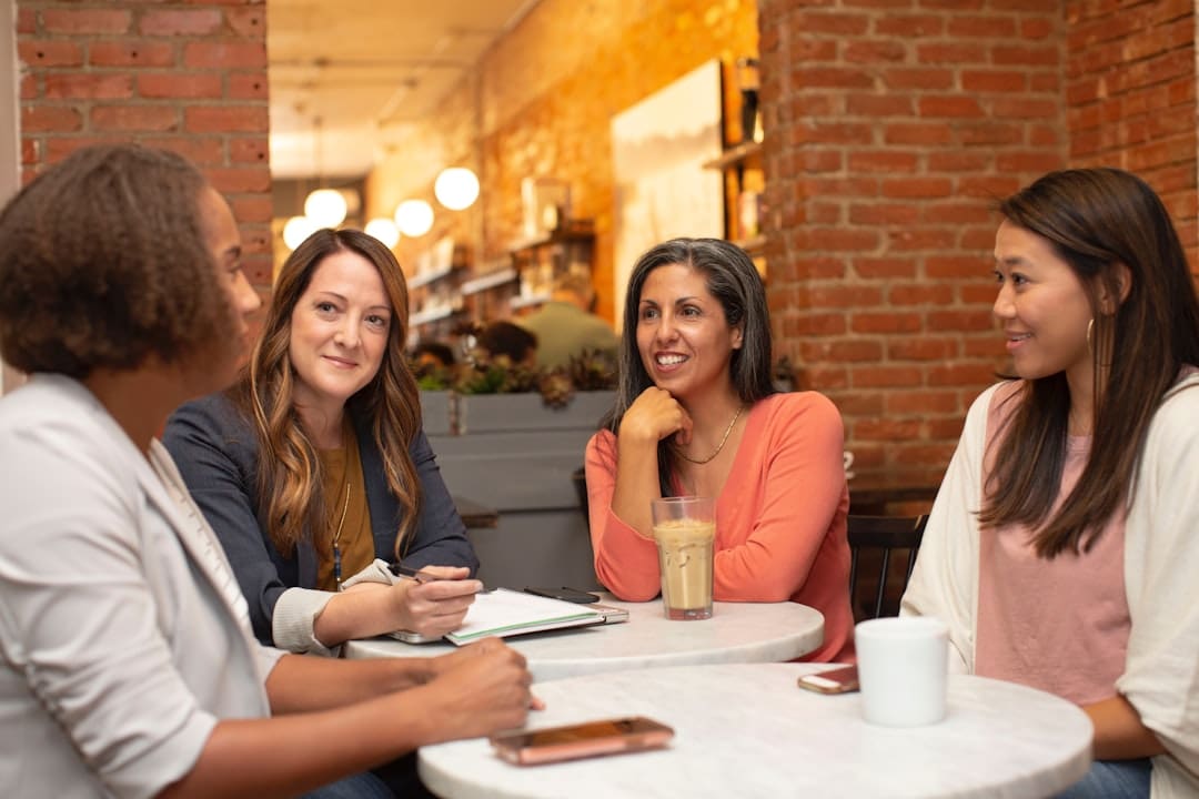 service dog retirement — four women chatting at cafe table