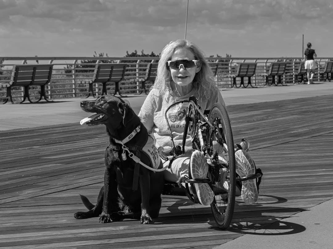 VA service dog benefits — Woman in handcycle with service dog on boardwalk