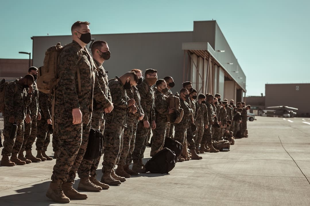 veteran suicide prevention — men in black and brown camouflage uniform standing on brown floor