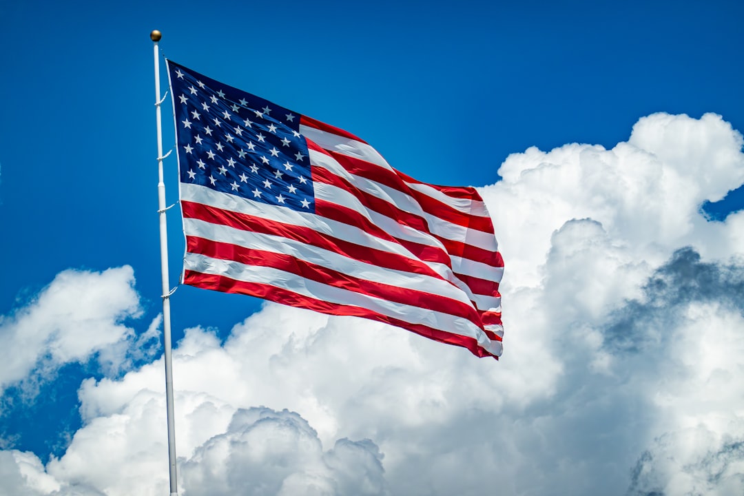 military handler civilian — An american flag flying high in the sky