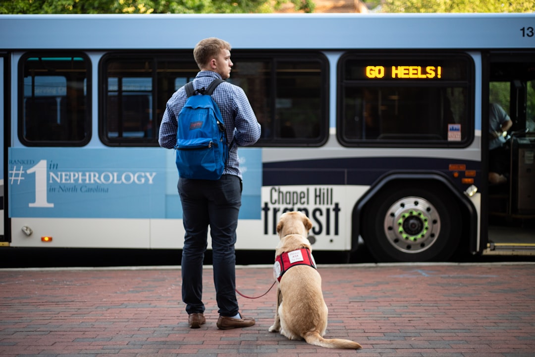 VA health care — man beside dog in front of bus